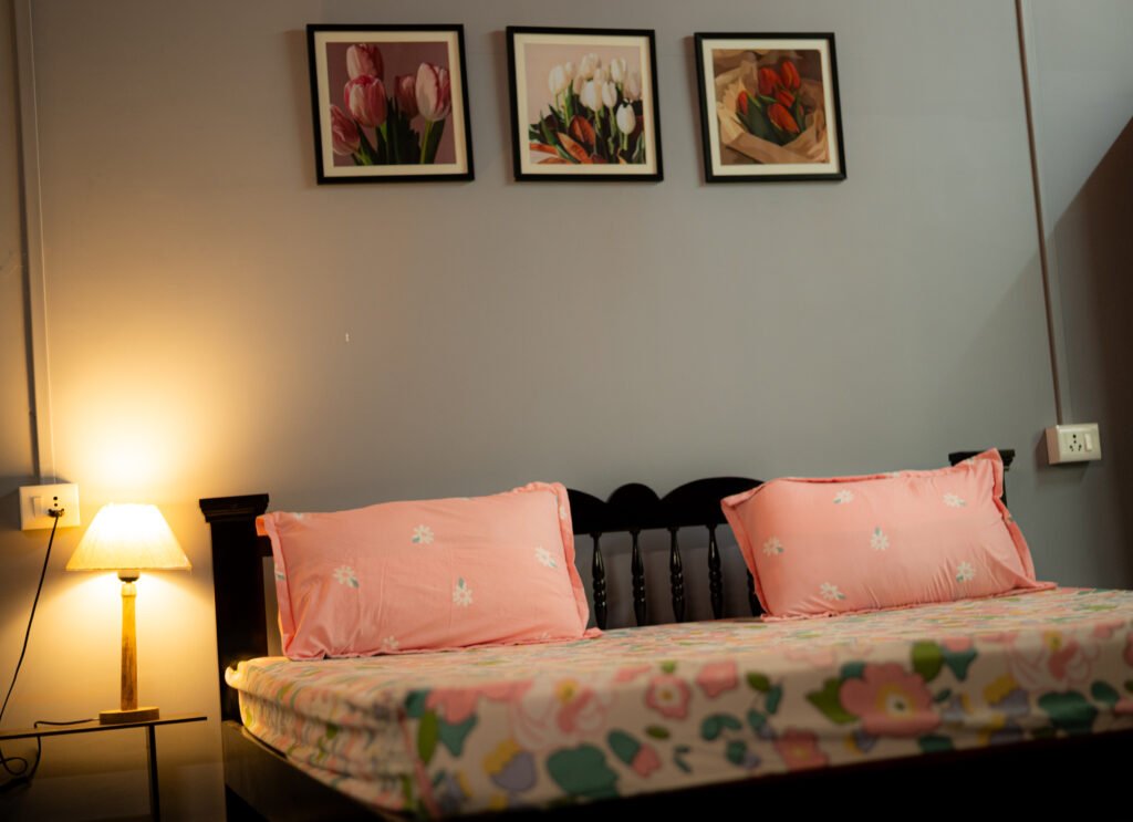 Bed with pillows, painting and bedsheet