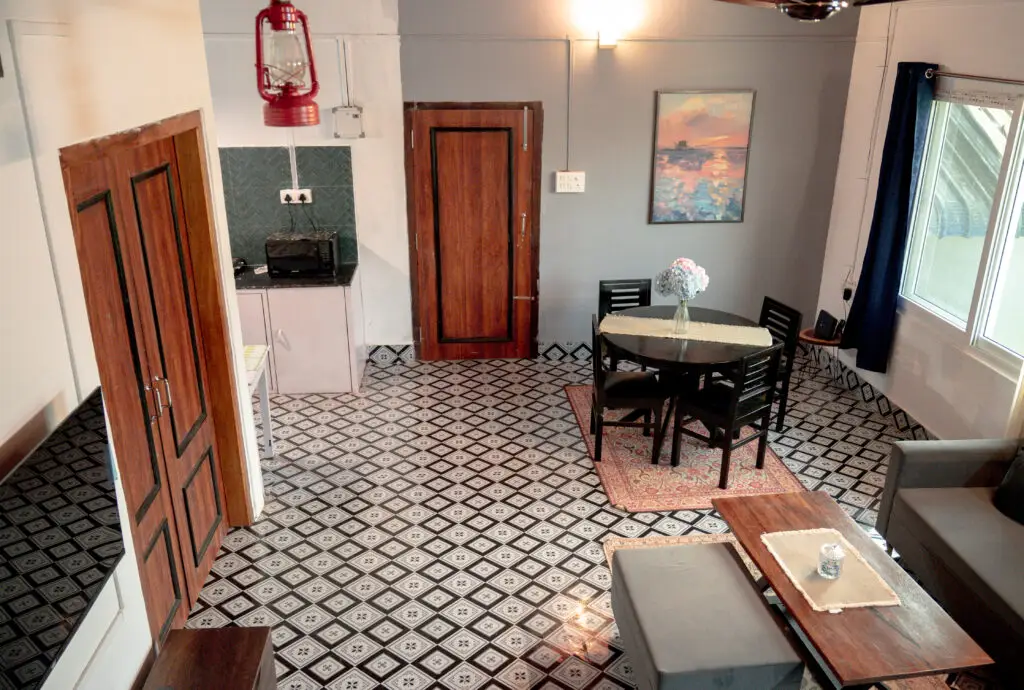 Lounge showing entrance door, room door, kitchen, and window