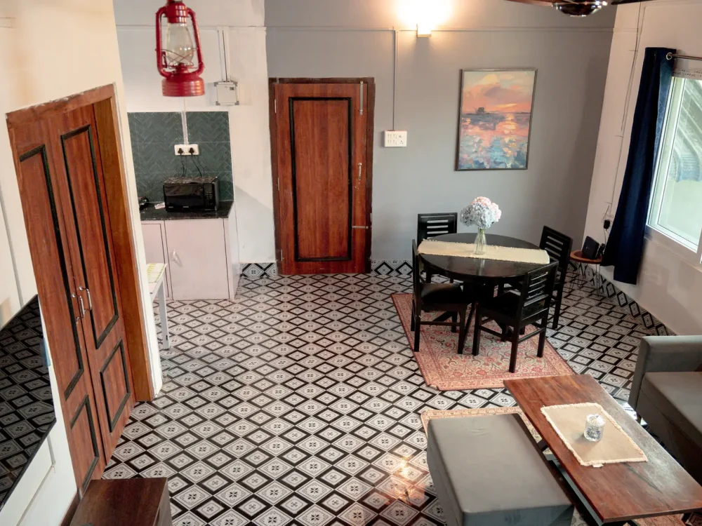 Lounge showing entrance door, room door, kitchen, and window