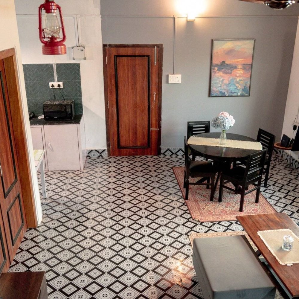 Lounge showing entrance door, room door, kitchen, and window